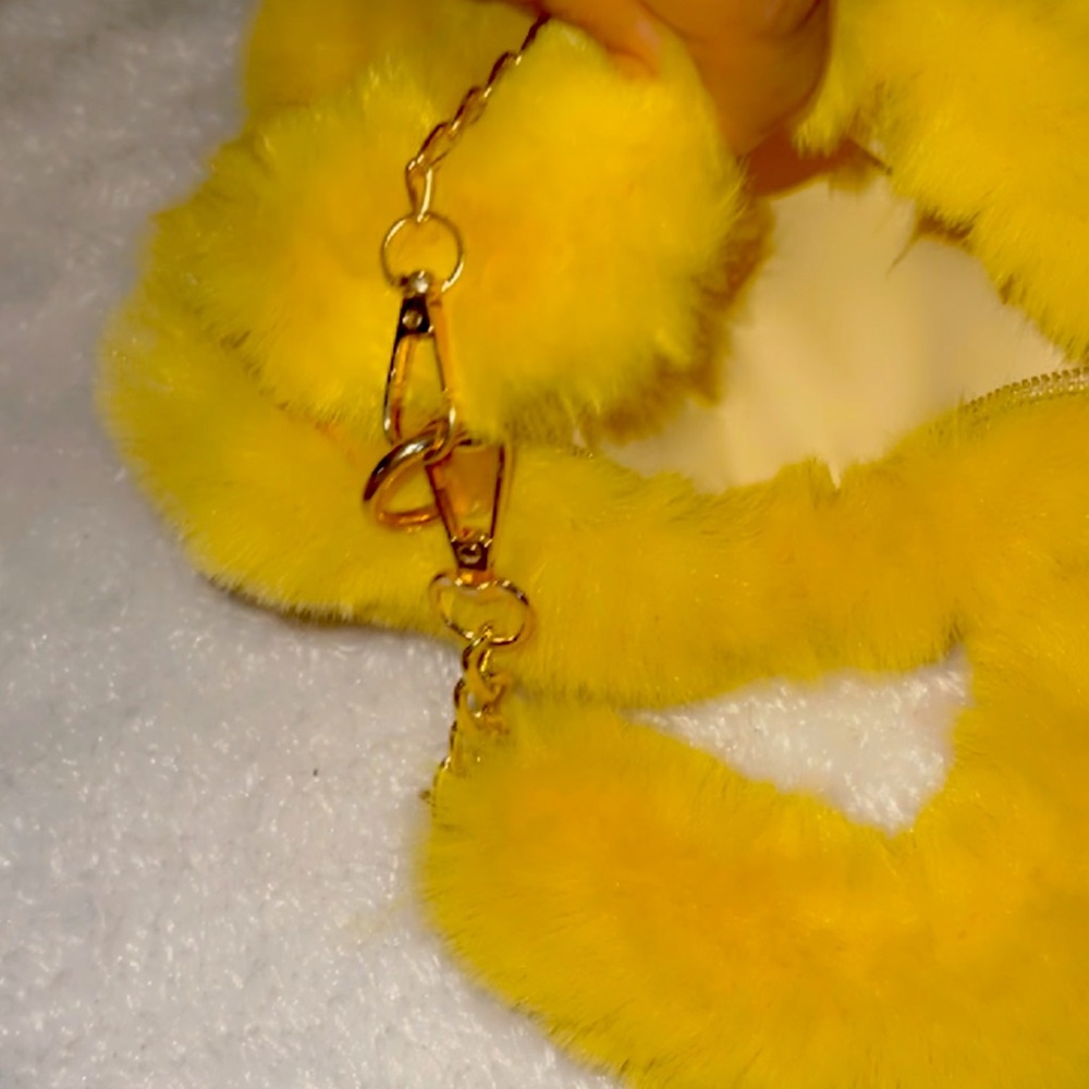Beautiful Sassy, yellow heart shaped fur purse with a zipper and fur balls